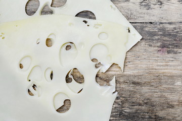 sliced cheese on a wooden board