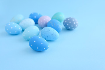 Easter eggs on blue background with empty space
