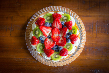 Cake with cream, strawberry, blueberry and kiwi