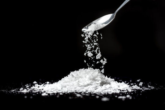 Sea flake salt isolated on black background
