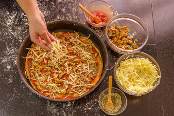 Preparing homemade pizza with cheese and mushrooms