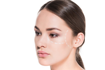 Fototapeta premium attractive young woman with dotted line drawn on face for plastic surgery isolated on white