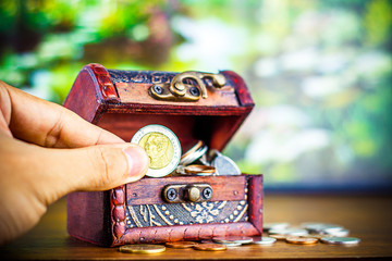 Saving money concept preset putting money coin stack growing business on bright light glowing bokeh background, business finance wealth and success concept.