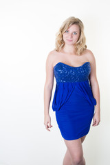 Portrait of beautiful model in blue dress with blond shoulders