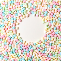 Colorful mini marshmallows background frame. Copy space for text.