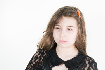 a beautiful young girl sitting sadly