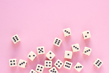Gaming dice with copy space on pink background. Concept for games, game board, presentation,...