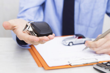 business man hand with keys and car control