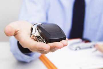 business man hand with keys and car control