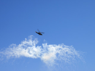 Helicopter flying in the blue sky