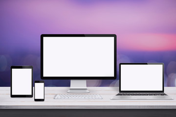 Responsive web design mockup. Devices with isolated screen on white wooden desk. Purple background.