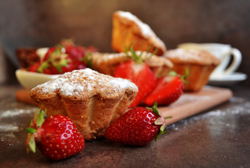Strawberry cupcakes on wooden board with fresh strawberries. 