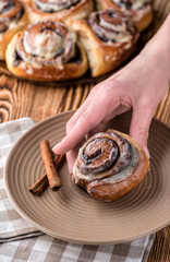 Women's hands takes bun