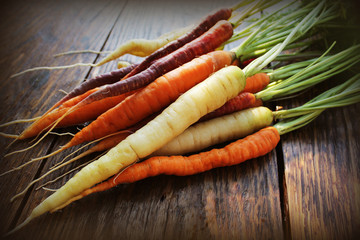 Carrots. Fresh colorful carrots on dark rustic background