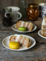 biscuit cake with white cream and macaroons