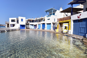 Traditional fishermen houses with the impressive boat shelters, also known as “syrmata” in Firopotamos of Milos, Greece