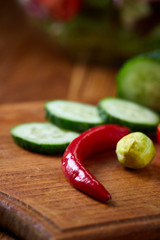fresh vegetables on the cutting board over wooden background, selective focus, shallow depth of field