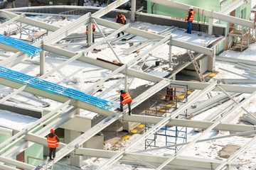 Construction site with workers on the building roof