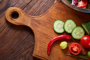 fresh vegetables on the cutting board over wooden background, selective focus, shallow depth of field