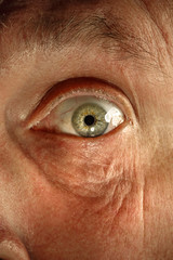 Close-up view on the eye of senior man.