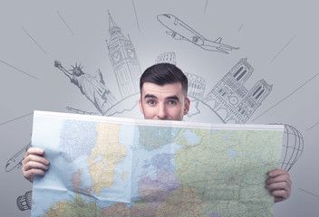 Handsome young man holding a map with famous sightseeing destinations above his head