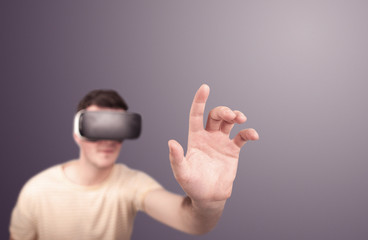 Plakat Young impressed man wearing virtual reality goggles