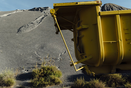 Old trailer abandoned  close to a black gravel pile at a quarry