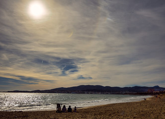 Calm beach afternoon in Palma de Mallorca. Mediterranean sea.Families and people enjoying the sun.