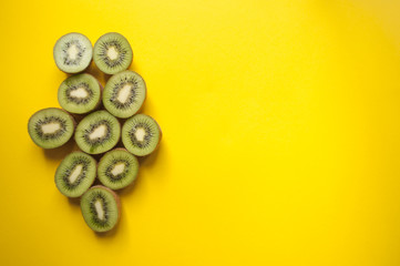 Kiwi fruit on yellow background.