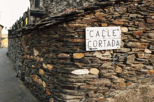Calle Cortada wooden sign on wall