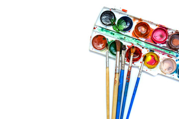 Old brushes, paints, palette of watercolor flat lay on a white background