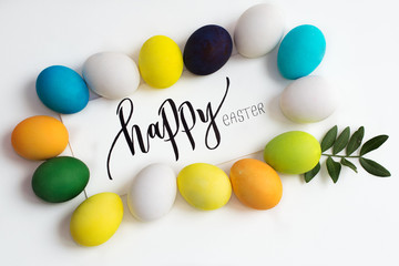 Easter festive colorful eggs on a white background with a greeting card calligraphy 