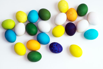 Easter festive colorful eggs on a white background. eggs yellow, blue, green and blue, orange and violet