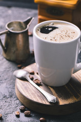 Black fried coffee beans on dark textured background