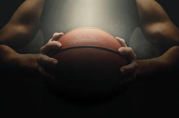 Basketball player with ball over dark background