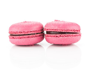 Pink French macarons isolated on white background two with raspberry jam.