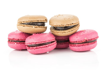 French macarons set (four pink with raspberry jam and two chocolate) isolated on white background.