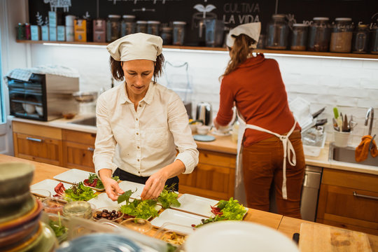 Cook preparing salad on kitchen