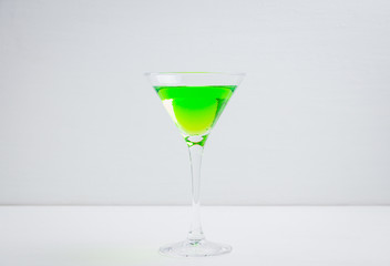 Apple martini cocktail on the white rustic background. Selective focus.