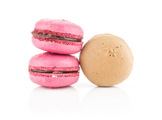 Three French macarons one chocolate and two with raspberry isolated on white background.