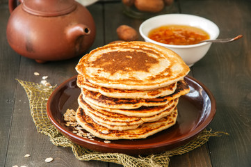 Oat flour small flatbreads served in a brown plate on a wooden background.