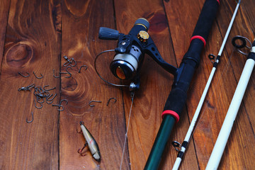 Variety of fishing tackle on a wooden background