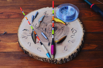 Variety of fishing tackle on a wooden background