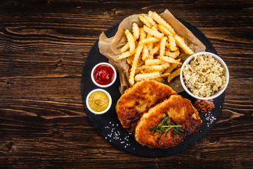 Fried pork chop, French fries and vegetable salad