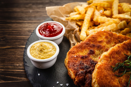 Fried pork chop, French fries and vegetable salad