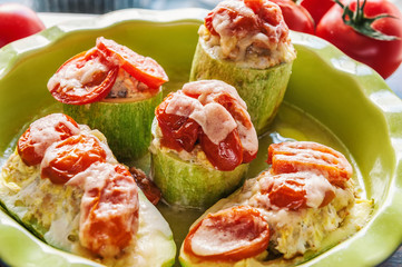 pieces of zucchini stuffed with vegetables rice with tomatoes and Parmesan cheese vegetarian food in the green dish
