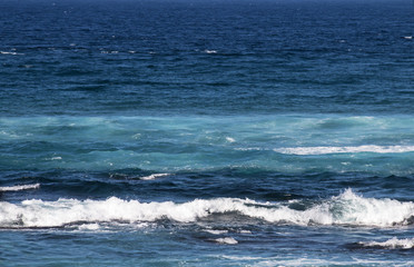 Close up of Waves Breaking Ripples on Sea Shore