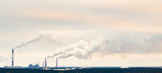 Smoke from the pipes of an industrial plant in the morning