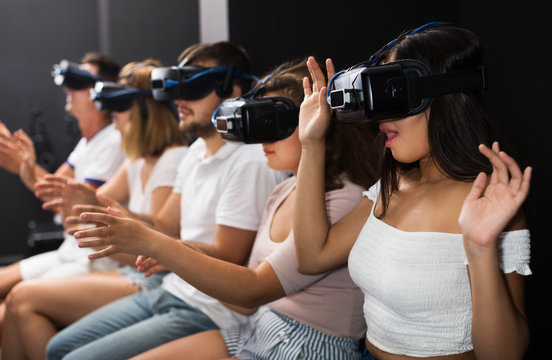 Girl watching exciting movie with VR glasses