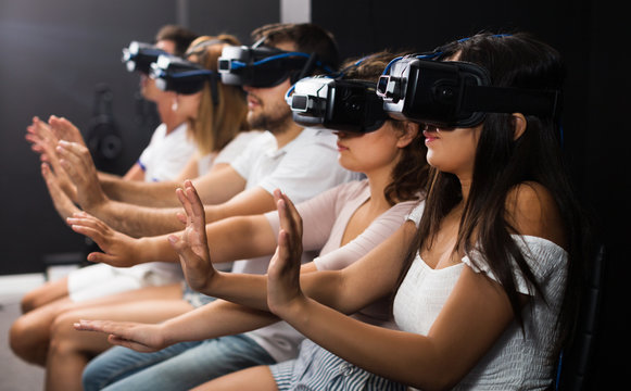 Woman watching exciting movie with VR glasses